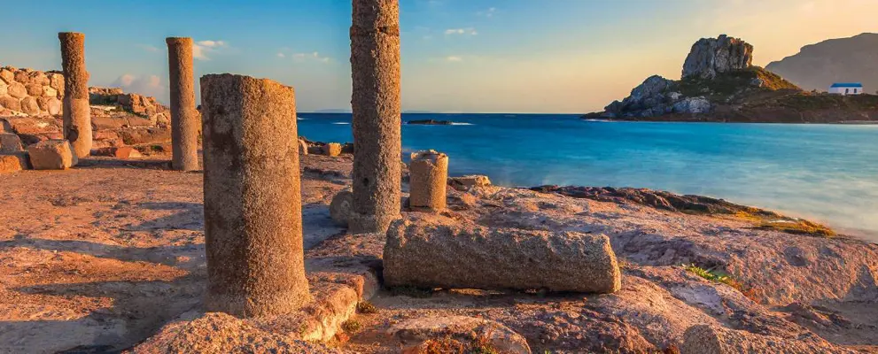 Ancient ruins in Greece overlooking deep blue sea